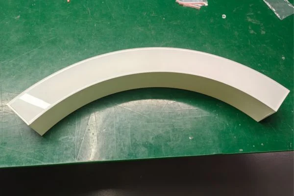 Curved linear lighting production photo showing curved fixture assembly